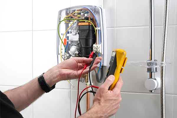 Technician performing electrical work during a shower replacement, provided by AD Plumbing, Heating, and Electrical.