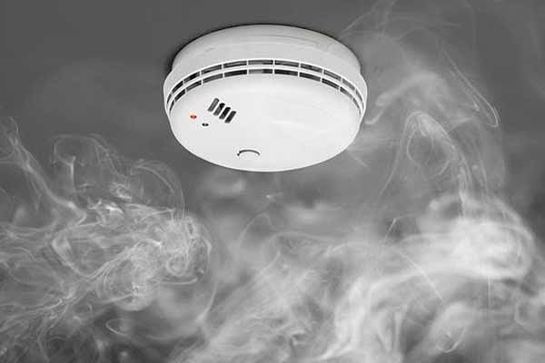 Close-up of a smoke alarm installed on a ceiling, provided by AD Plumbing, Heating, and Electrical.